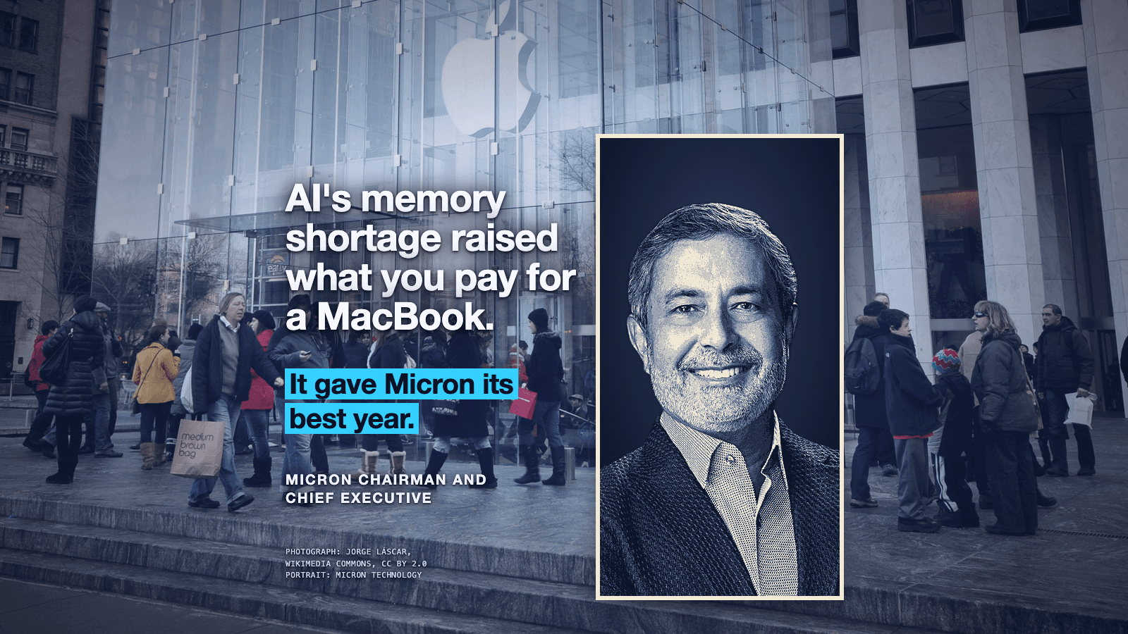 Apple's glass cube store on Fifth Avenue, graded blue: Apple's logo hangs high inside the glass, above a crowd of shoppers in winter coats walking and standing in line on the plaza. At the right, a tall portrait panel in a thin cream frame shows the head and shoulders of a smiling person with short grey hair and a grey beard, in a dark jacket over a collared shirt, toned in navy and cream against a dark navy background. At the left, in large white type with a dark glow around the letters: AI's memory shortage raised what you pay for a MacBook. Below it, in dark letters on bright cyan bars: It gave Micron its best year. Under that, small white capitals read MICRON CHAIRMAN AND CHIEF EXECUTIVE. At the lower left, small credit lines read PHOTOGRAPH: JORGE LÁSCAR, WIKIMEDIA COMMONS, CC BY 2.0 and PORTRAIT: MICRON TECHNOLOGY.